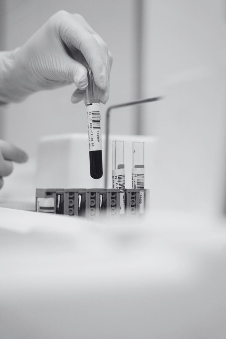 Article cover image showing blood samples and a hand