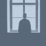 Man in front of window